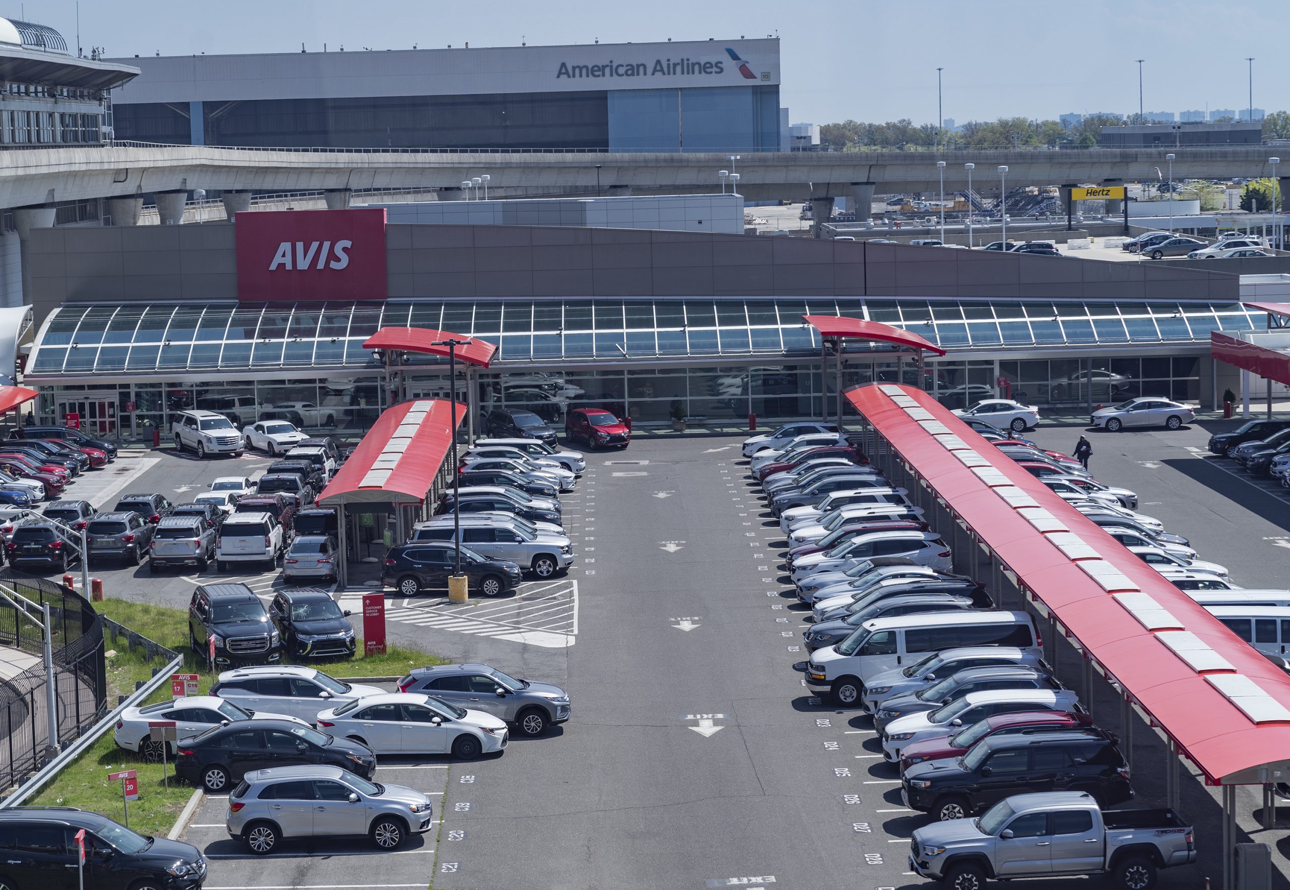 A line of rental cars at an Avis center