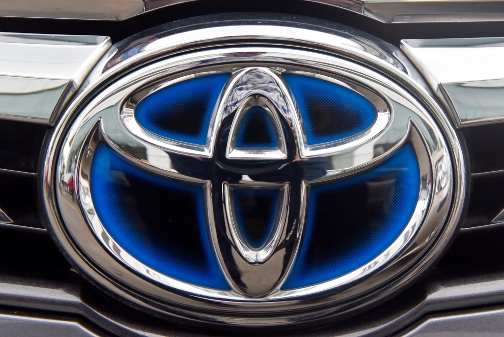 The Toyota logo seen on one of the brand's hybrid models