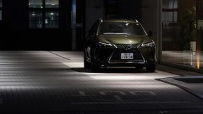 2021 Lexus UX250 parked in the dark on a gray brick paved street