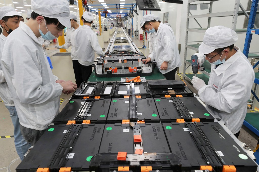 Workers making lithium ion batteries for electric cars