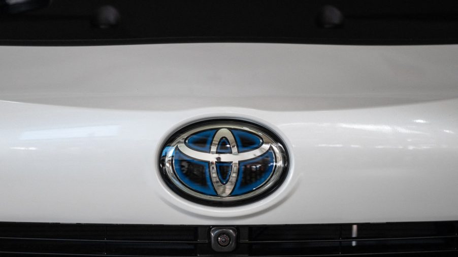 a Toyota logo on the front of a white Toyota car