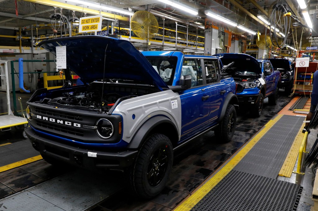 A four-door blue hardtop Ford Bronco on the production line in Michigan