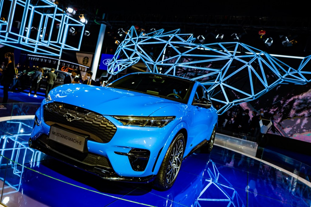 An electric blue Mach-E at an auto show in China
