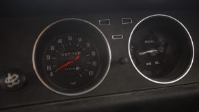 An odometer on an older car, showing lower mileage
