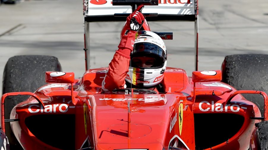 Formula 1 driver Sebastian Vettel celebrates a win from the seat of his car