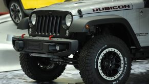 A silver Jeep Wrangler with beadlock wheels
