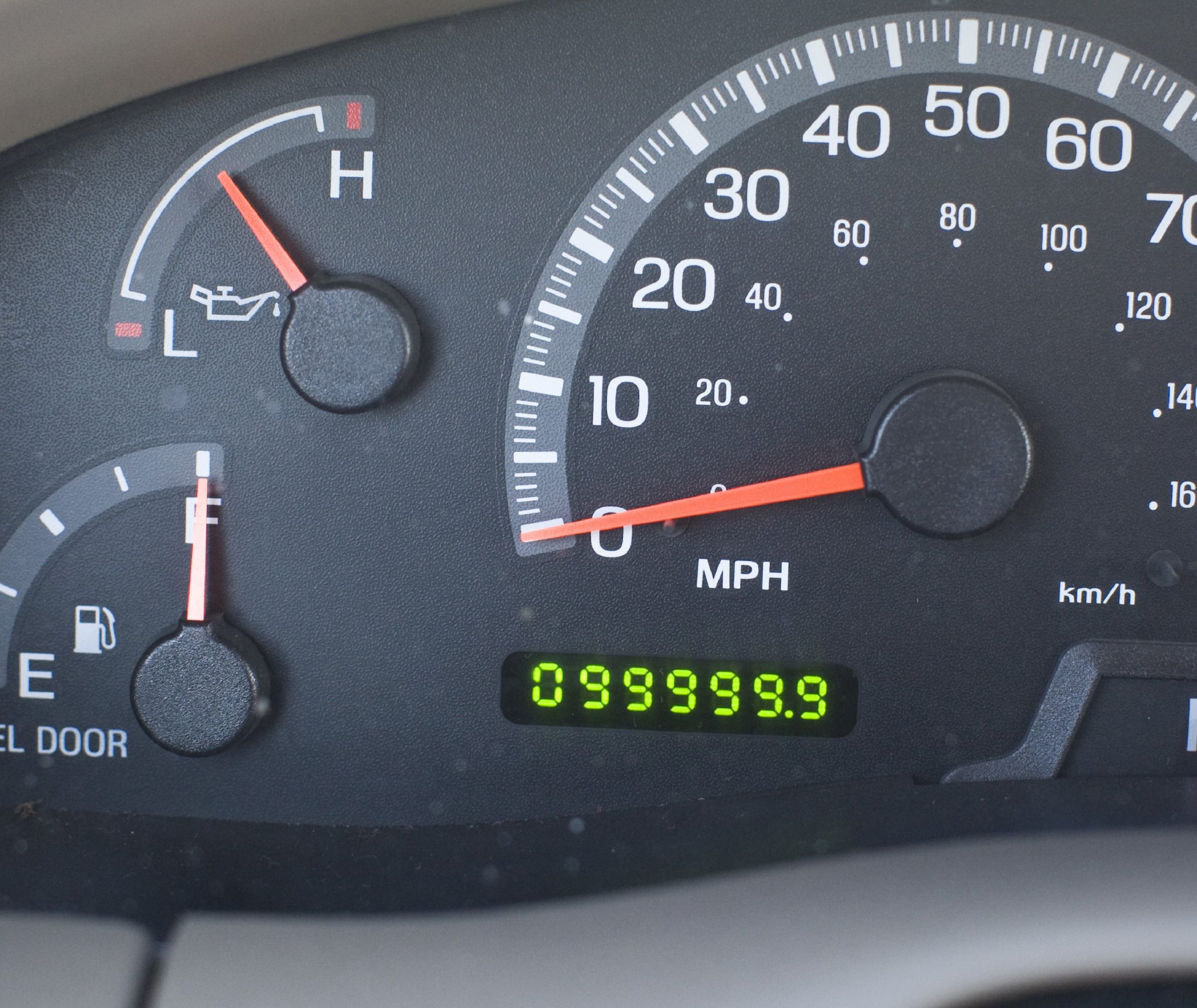 A car's odometer, on the cusp of going over 100,000 miles