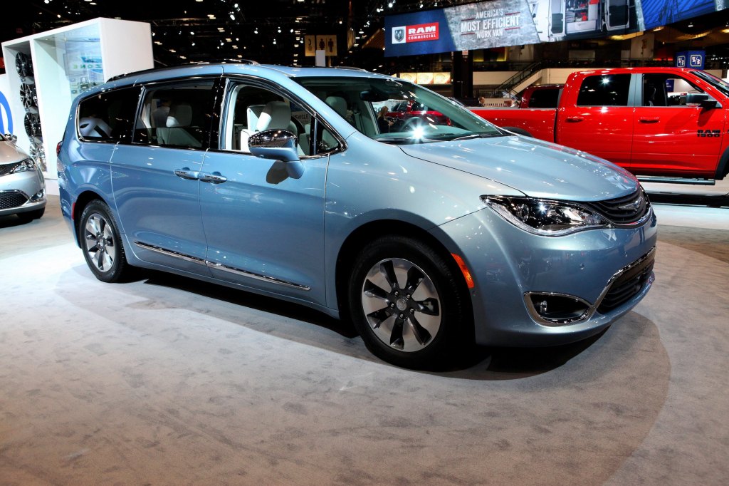 a blue Chrysler Pacifica minivan on display at an indoor auto show