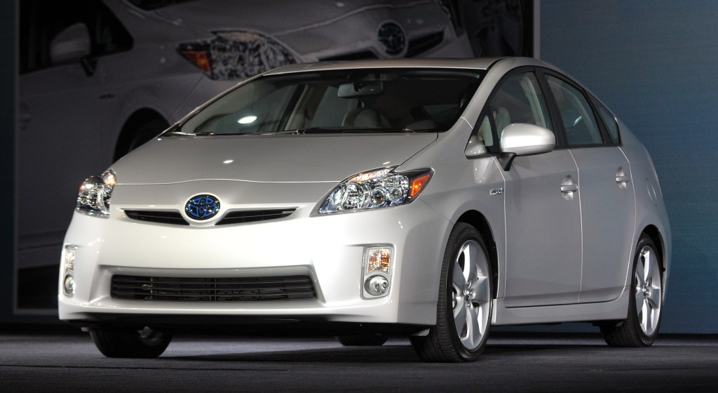 a silver 2010 Toyota Prius on display at an indoor auto show.