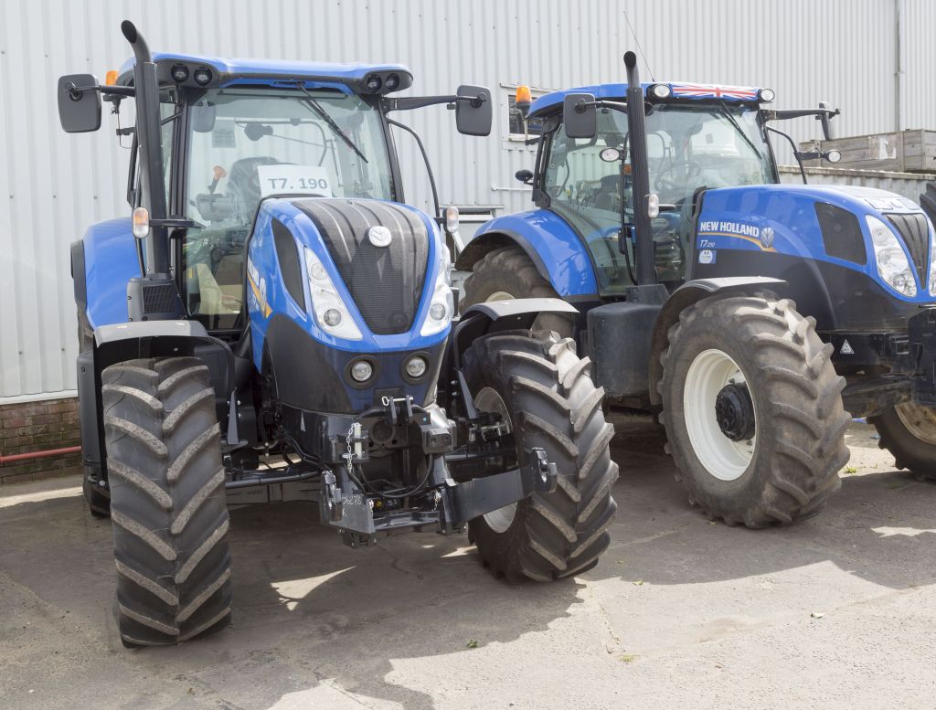 two New Holland tractors side by side at a dealer 