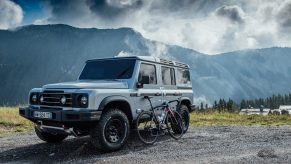 The Ineos Grenadier posed on a cliffside with one of the cycling team's bikes
