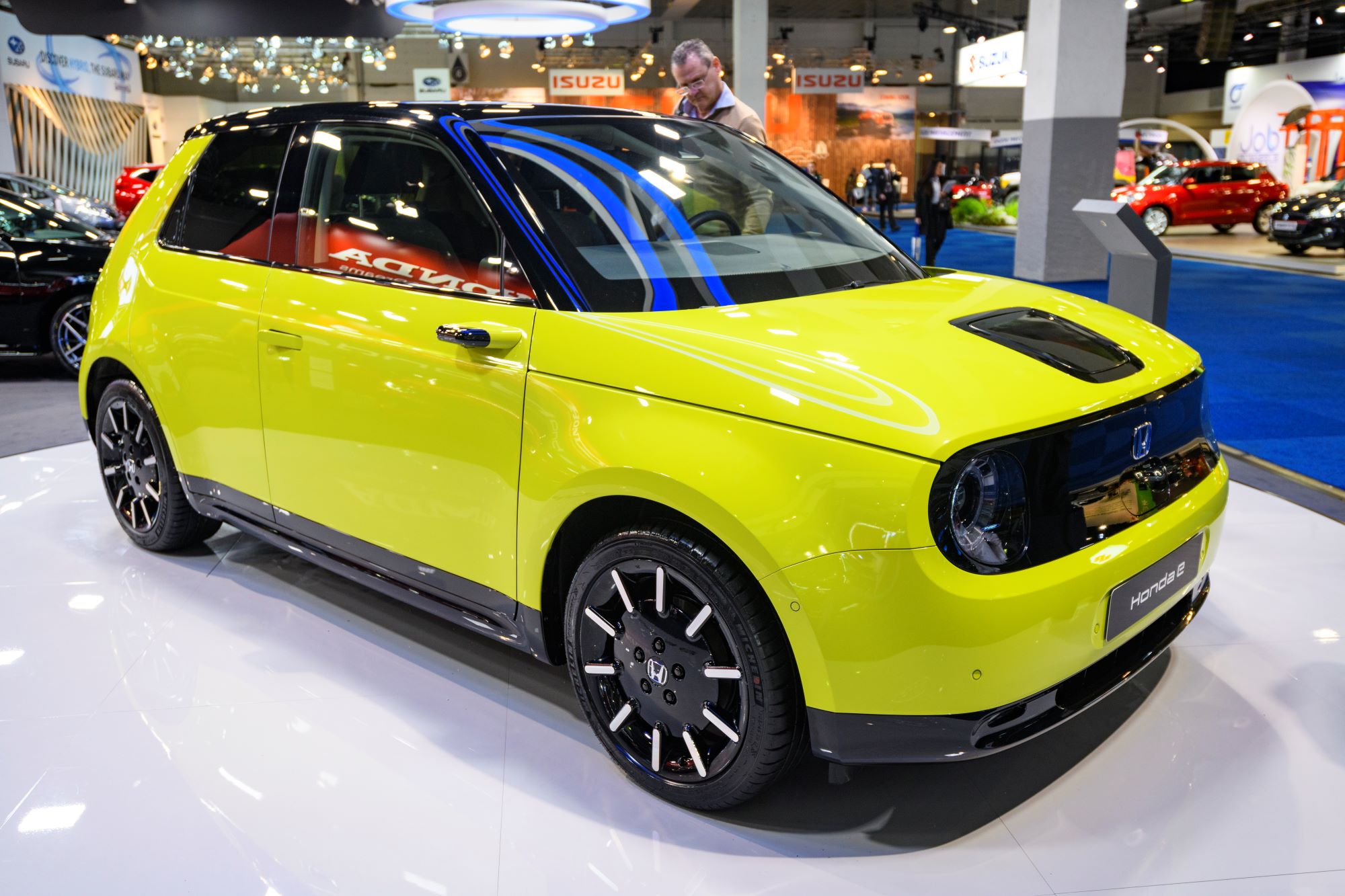 A yellow Honda e model on display at the Brussels Expo