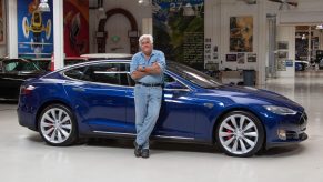 Jay Leno with his blue Tesla Model S