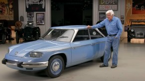 Jay Leno with his light-blue 1967 Panhard 24 BT in his garage
