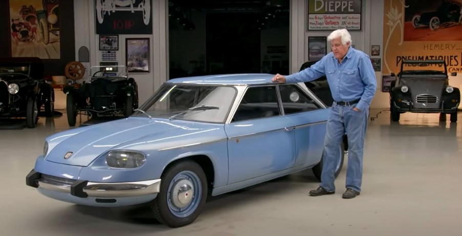 Jay Leno with his light-blue 1967 Panhard 24 BT in his garage