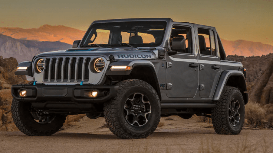 The 2021 Jeep Wrangler 4xe plug-in hybrid model parked in a desert and surrounded by rocks