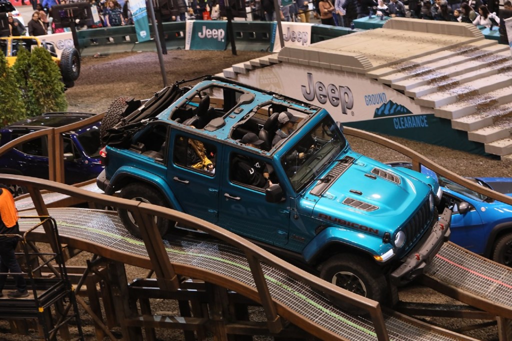 A turquoise-blue Jeep Wrangler Rubicon on the 2020 Chicago Auto Show's off-road test course