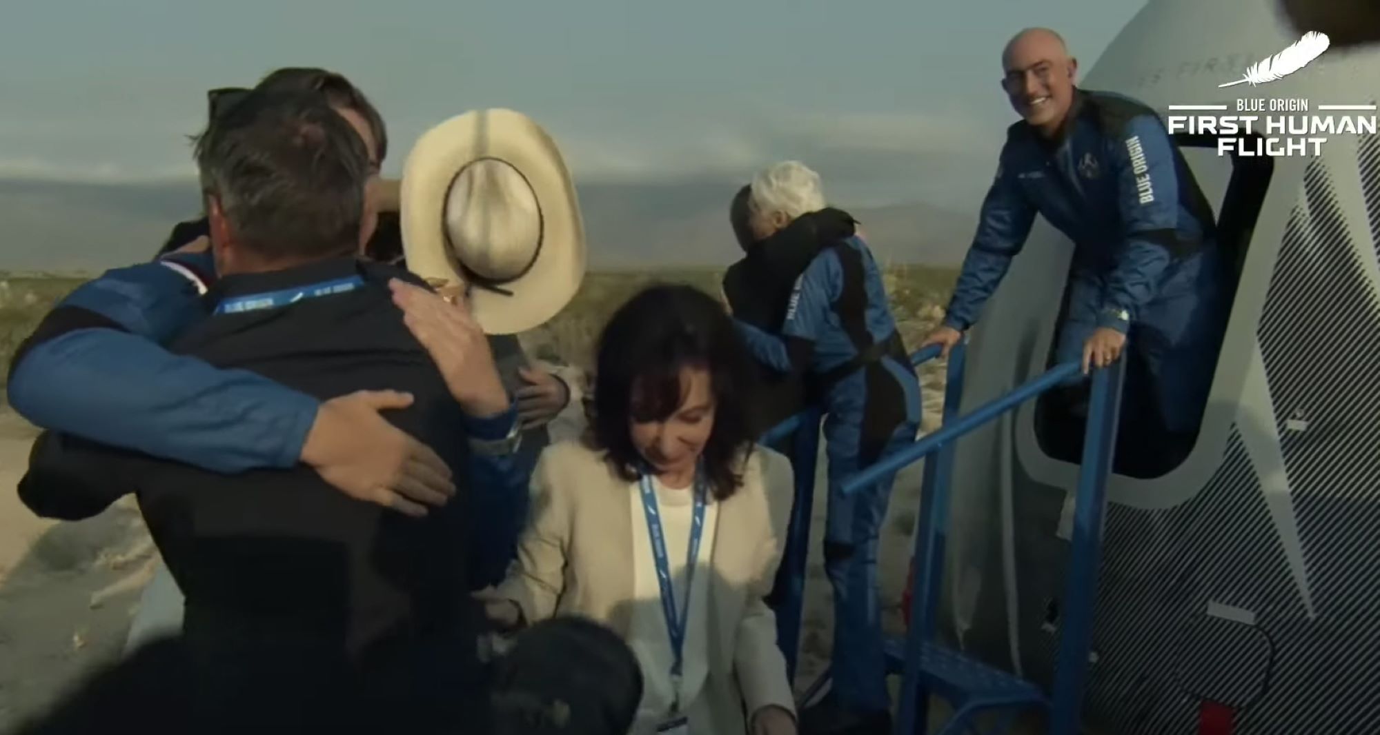 Jeff Bezos coming off the rocket New Shepherd with his crew dressed in space suits.