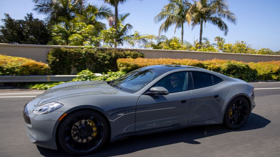 The Karma GS-6 luxury sports car driving near palm trees