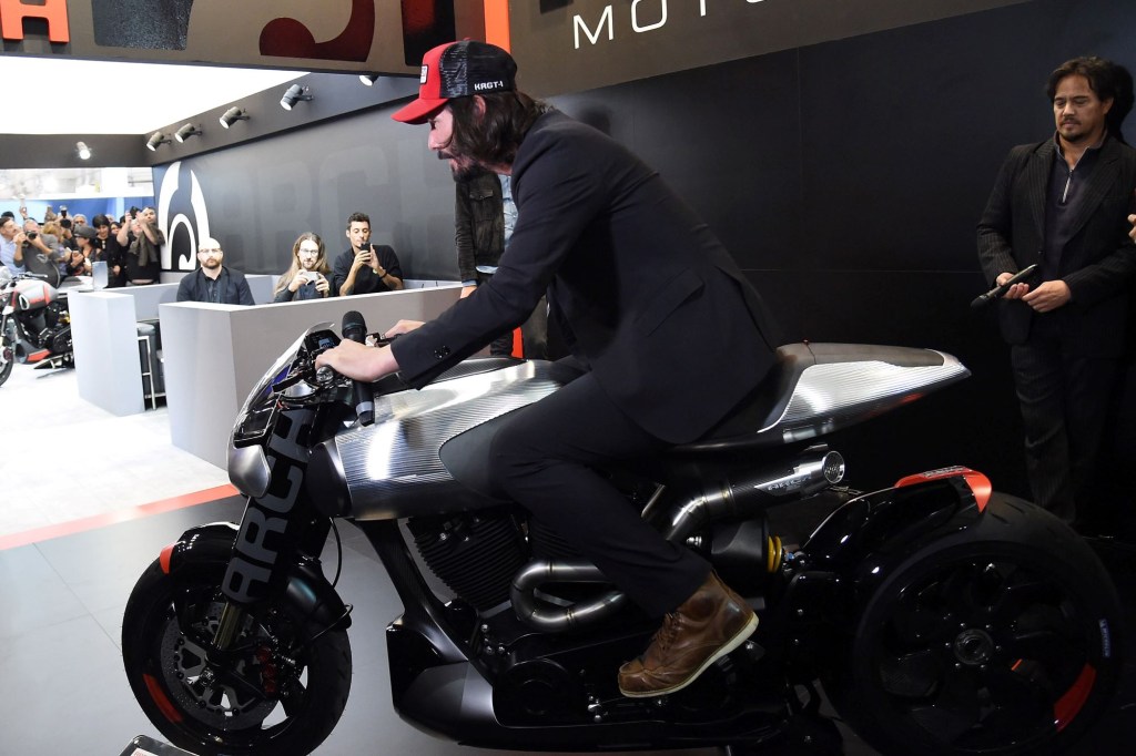 Keanu Reeves on a motorcycle during an ARCH conference at EICMA 2017