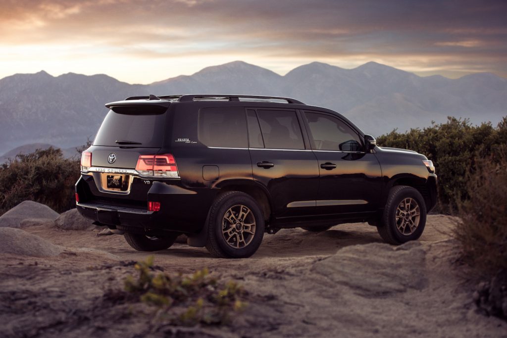 A black Toyota Land Cruiser parked overlooking an mountain range