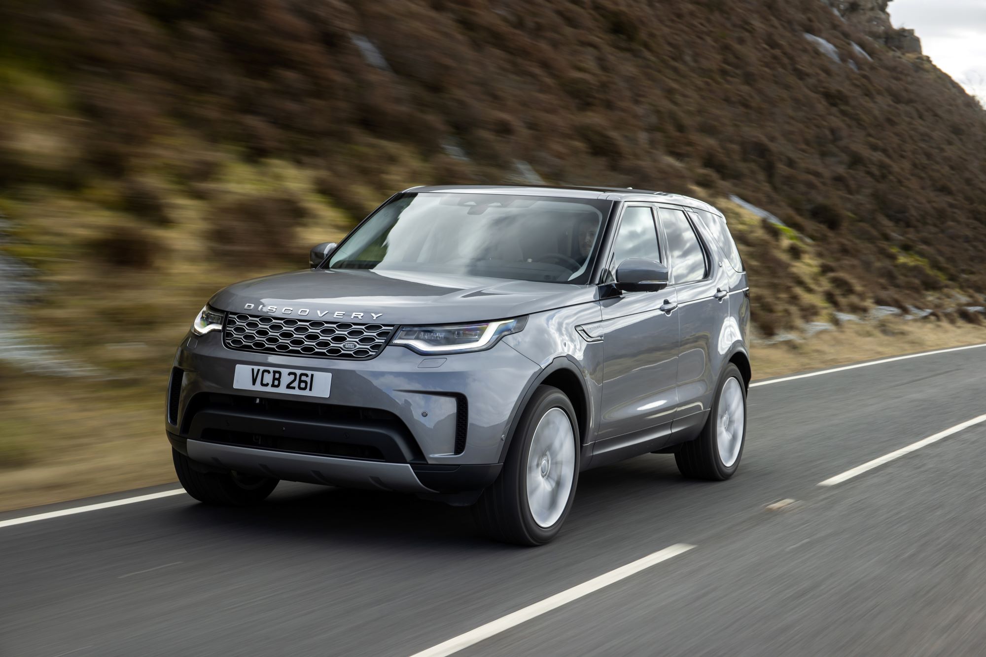 The Land Rover Discovery MHEV model driving on a country highway