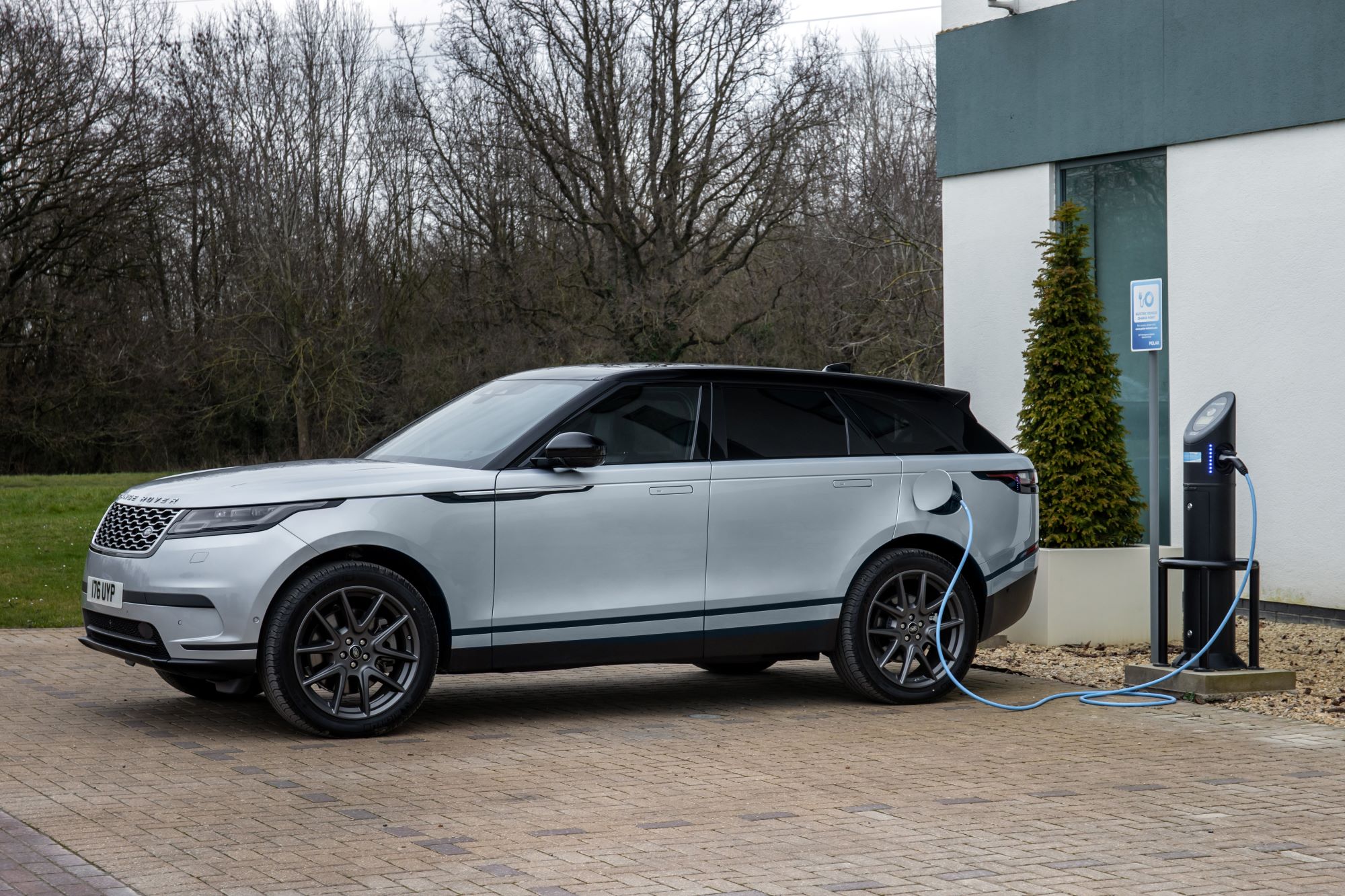A Land Rover Range Rover Velar PHEV model connected to a charging station
