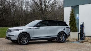 A Land Rover Range Rover Velar PHEV model connected to a charging station