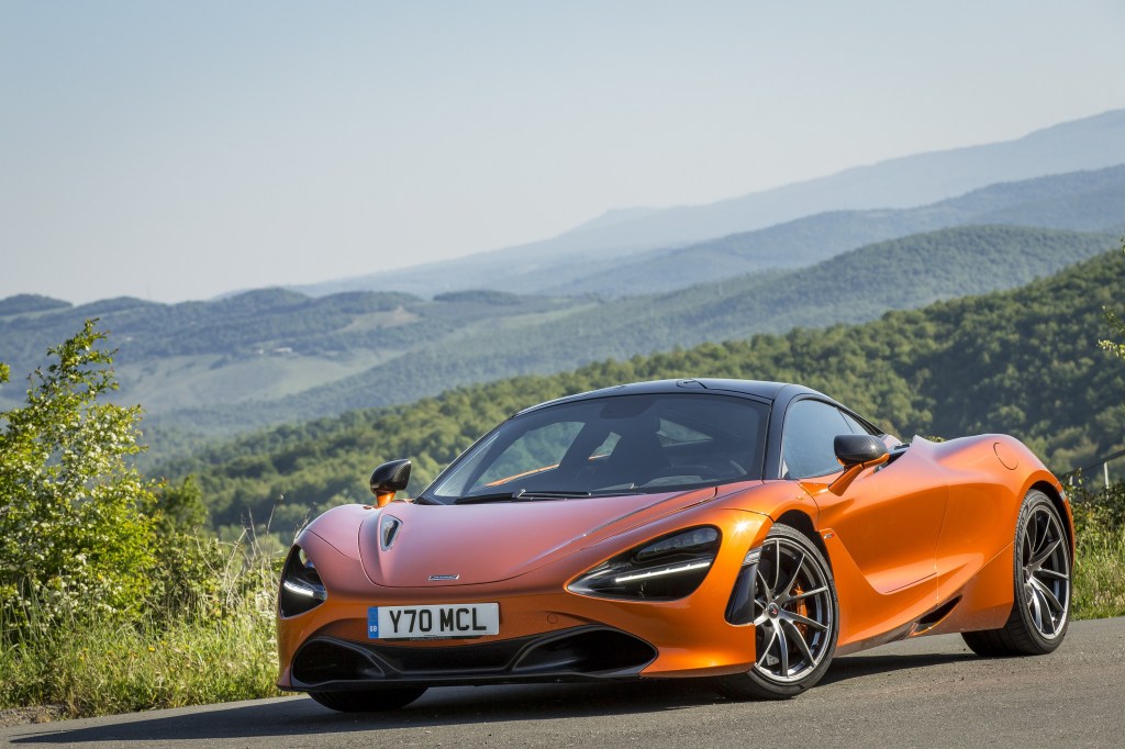 The orange Mclaren 720s on a country road