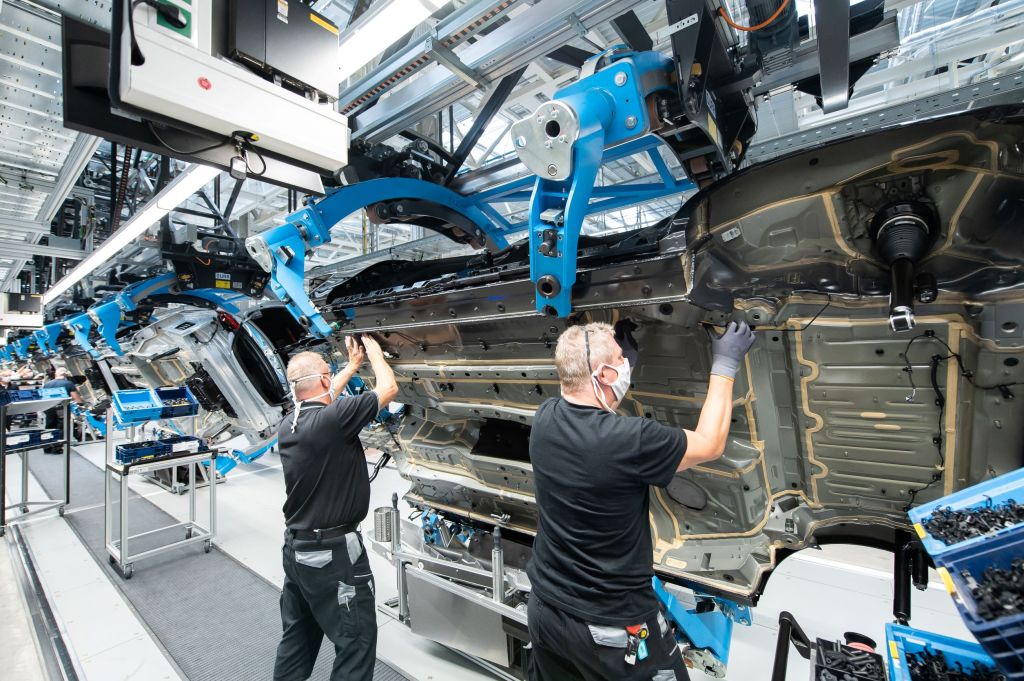 Mercedes-Benz employees install brake lines in a 2021 S-Class