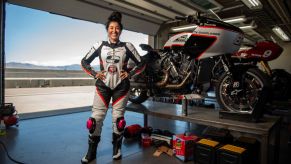 Patricia Fernandez with her Saddlemen King of the Baggers Indian Challenger in a track-side garage