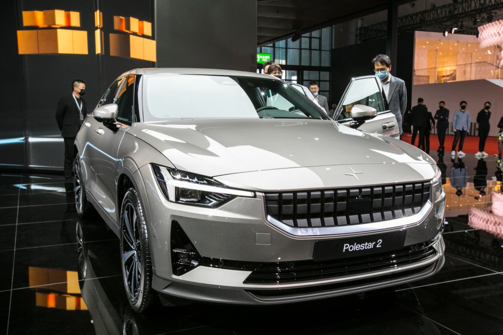 Visitors look at a Polestar 2 electric car during Auto Shanghai in April 2021 in Shanghai, China