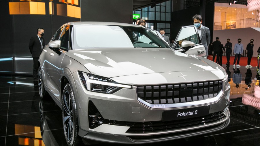 Visitors look at a 2021 Polestar 2 electric car during Auto Shanghai in April 2021 in Shanghai, China
