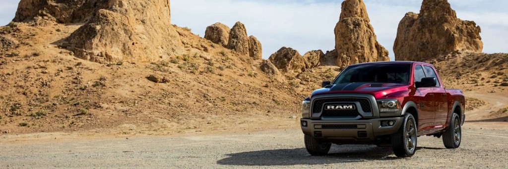 A maroon 2021 Ram 1500 Classic driving in a desert.