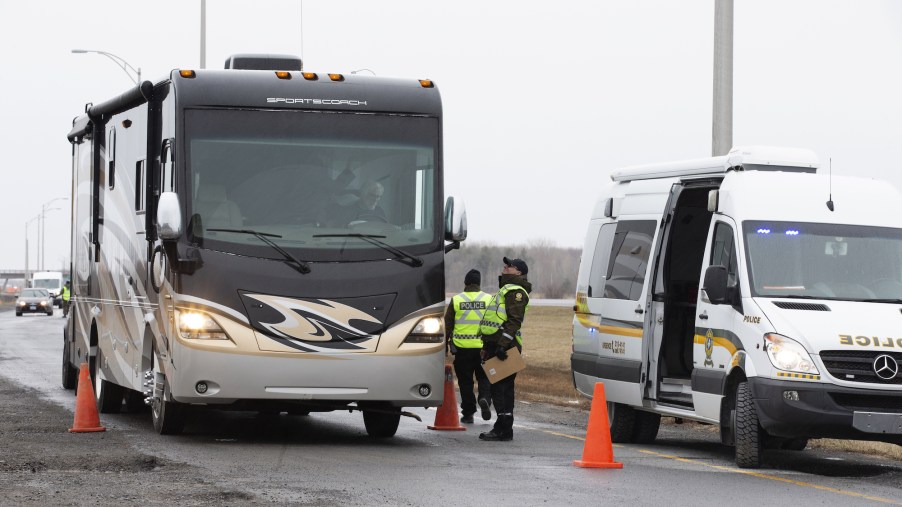 Police officers stop an RV at a checkpoint on the Quebec-Ontario border in Canada in April 2020