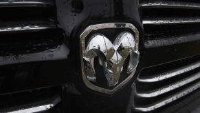 A Ram logo embedded on the grille of a pickup truck