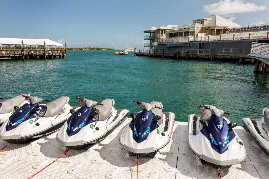 A row of rental jet skis on a marina