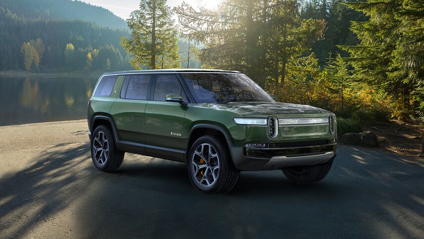 A green 2021 Rivian R1S parked in a driveway