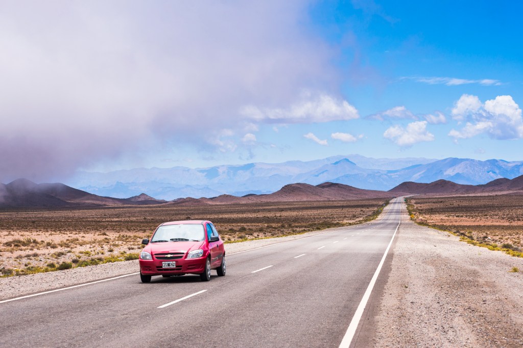 Car Driving Down Empty Desert Highway