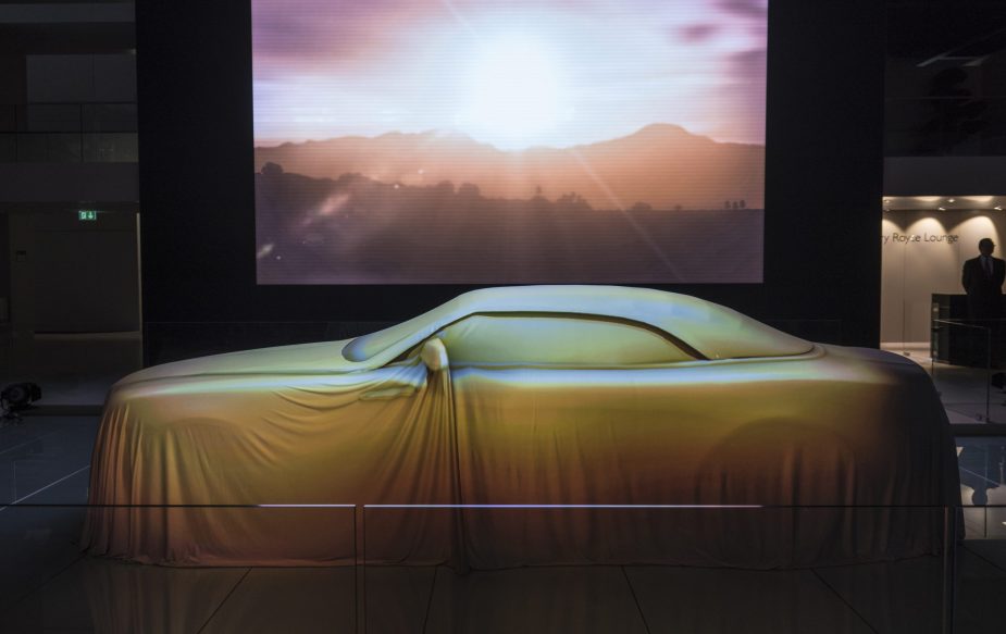 The Rolls-Royce Dawn convertible under a sheet at its debut