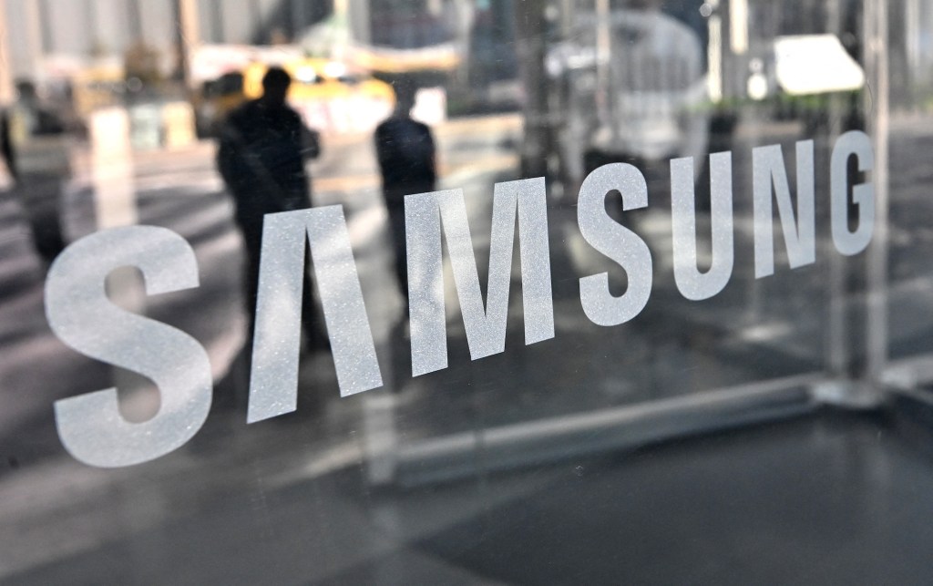The Samsung logo on a window of a retail store