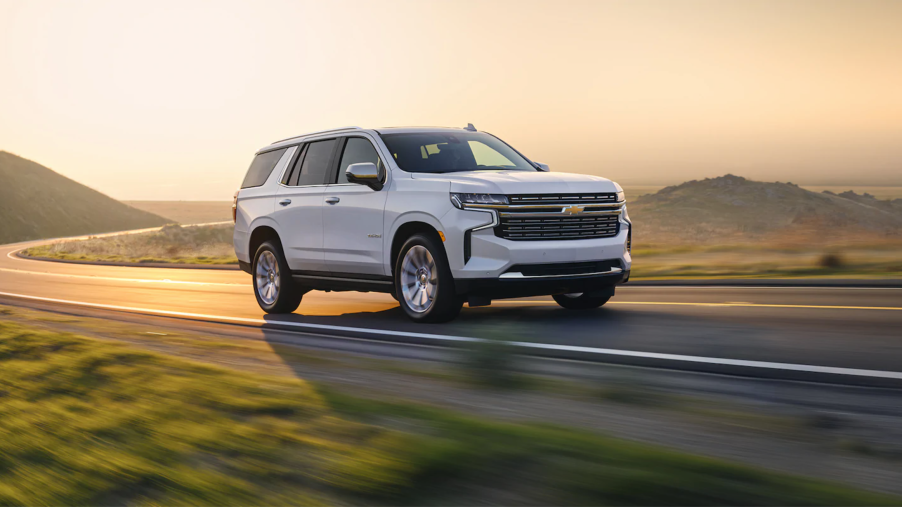 A white 2021 Chevy Tahoe driving at dusk