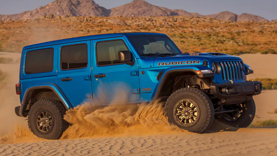 A blue 2021 Jeep Wrangler Rubicon 392 kicking up sand