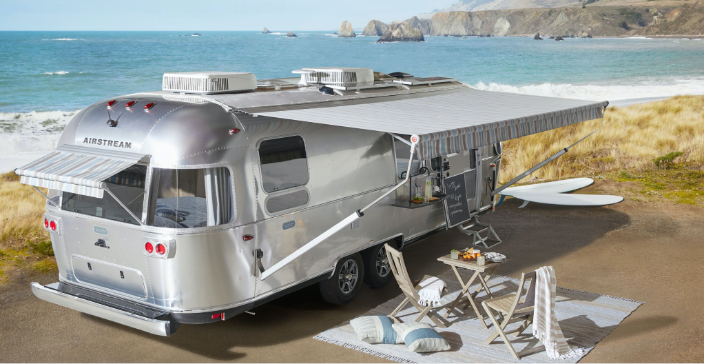 The Airstream Pottery Barn Travel Trailer parked near the beach
