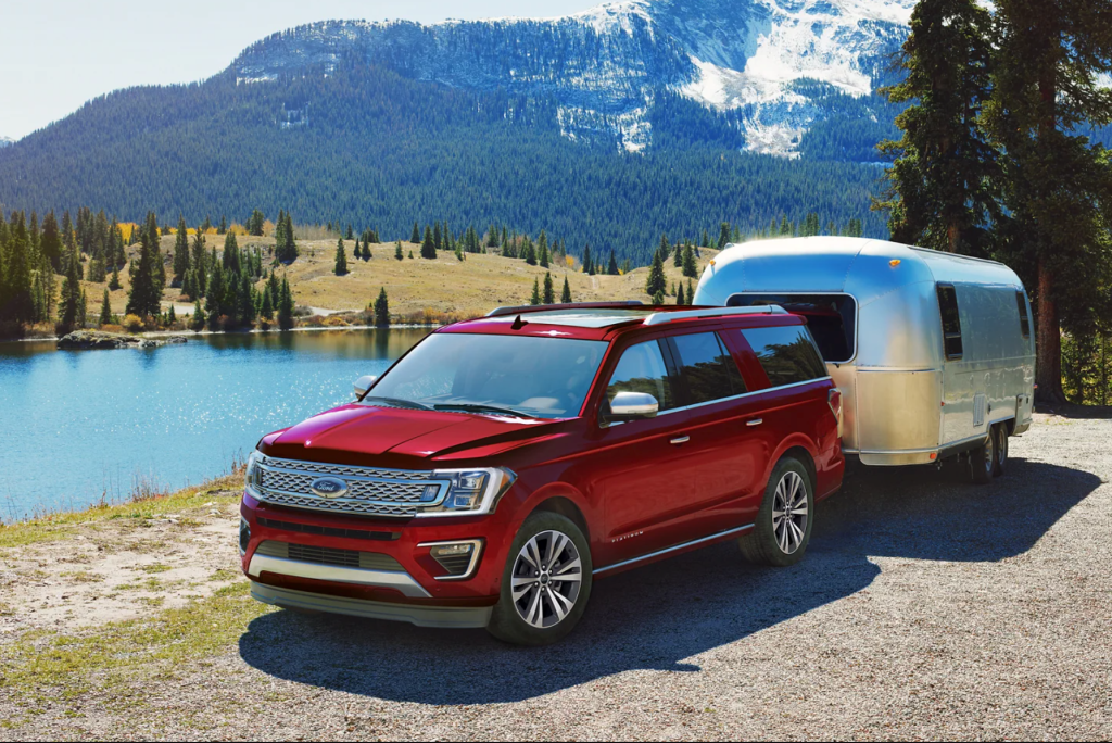 A red 2021 Ford Expedition towing an Airstream trailer shows of one of the best SUVs for cargo space. 
