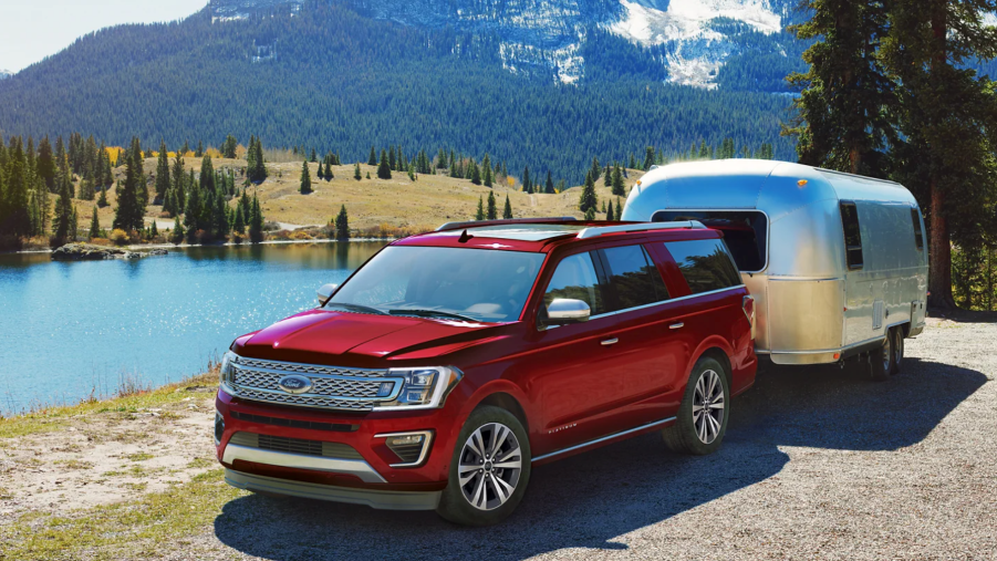 A red 2021 Ford Expedition towing an Airstream trailer