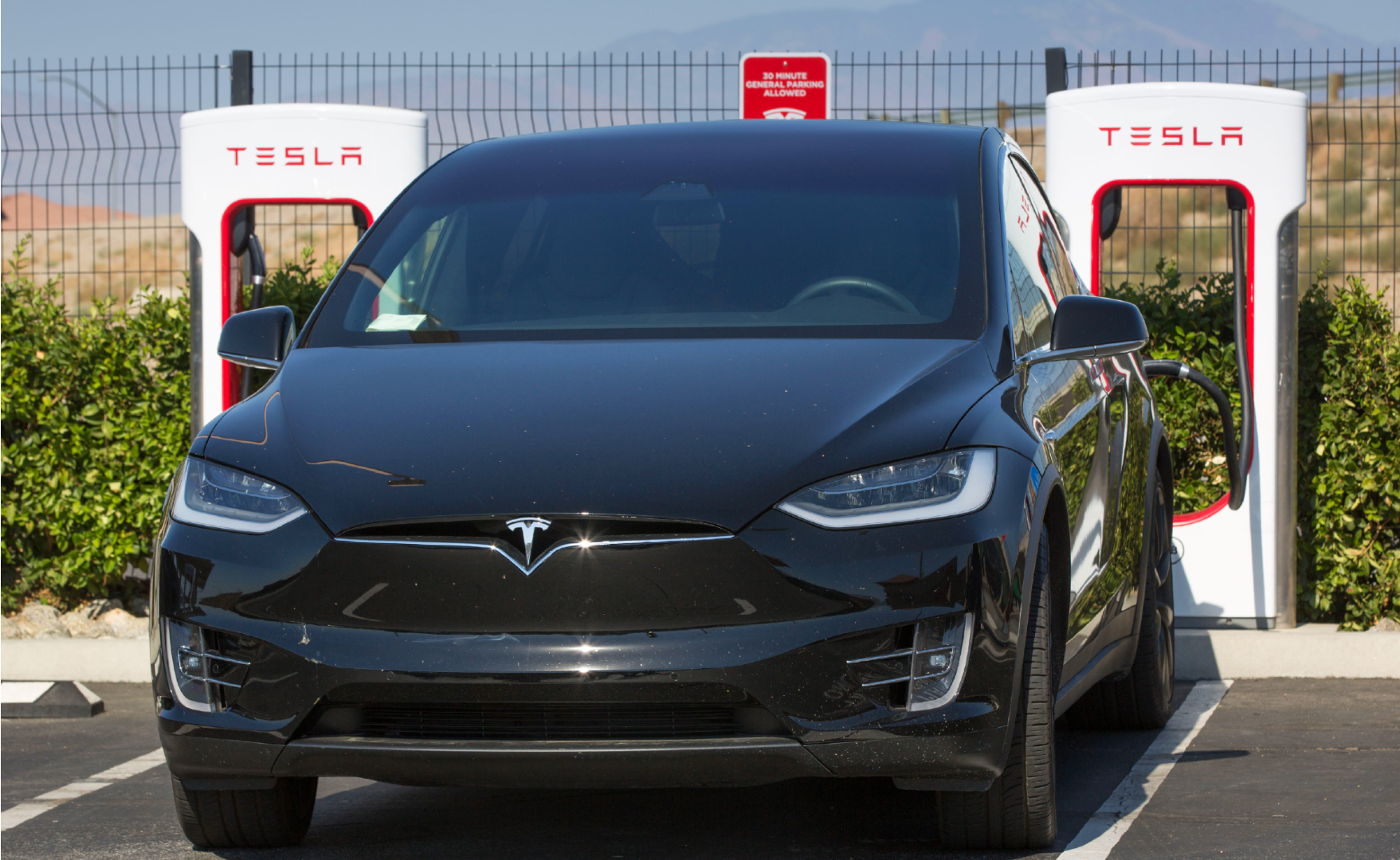 A Tesla electric vehicle supercharging station near the Tejon Ranch Outlet Stores in the Tehachapi Mountains, adjacent to Interstate 5, is viewed on July 7, 2021, near Lebec, California.