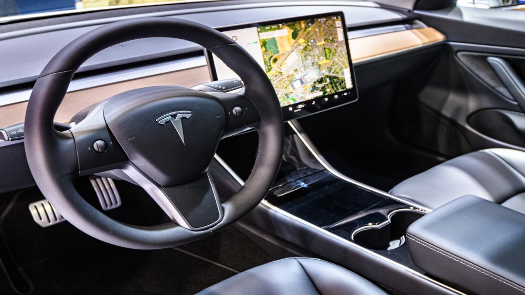 Tesla Model 3 compact full electric car interior with a large touch screen on the dashboard on display at Brussels Expo.