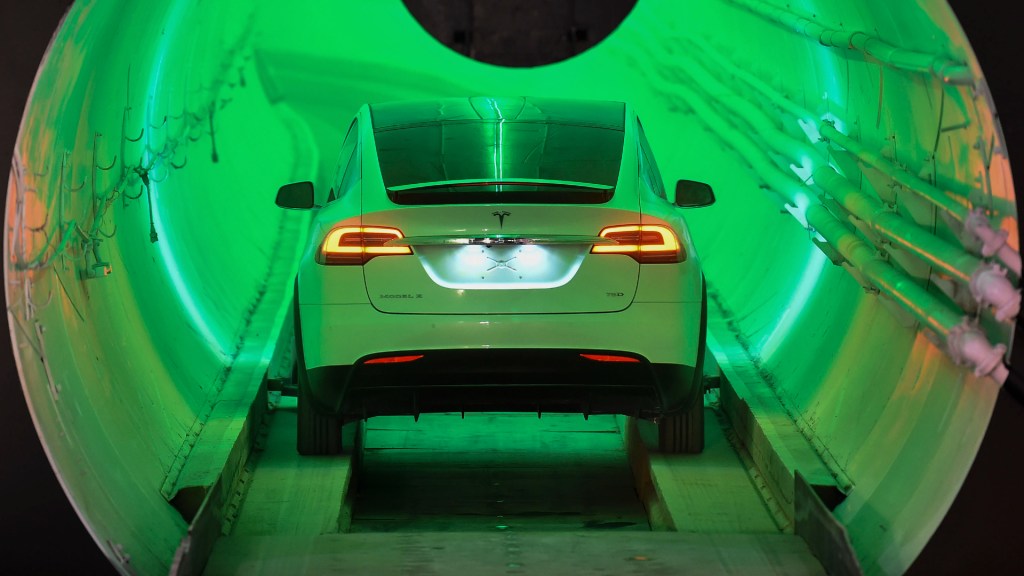 A modified Tesla Model X enters a tunnel before an unveiling event for The Boring Company. 