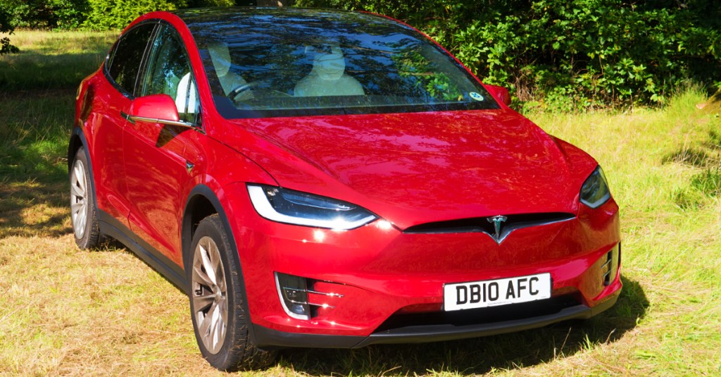 A red 2017 Tesla Model X electric vehicle.
